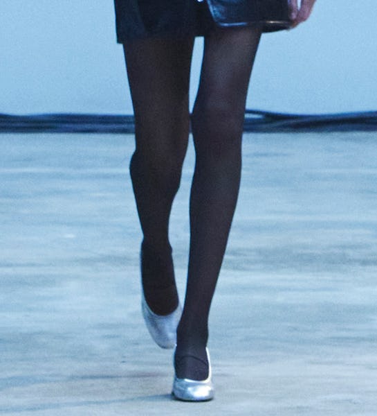a model wearing silver glove pumps on the Khaite runway
