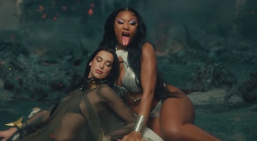 Megan Thee Stallion and Dua Lipa in "Sweetest Pie" music video sitting together wearing metallic and...