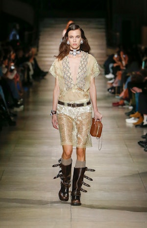 a model wearing brown leather moto boots on the Miu Miu runway