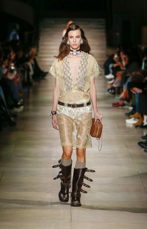 a model wearing brown leather moto boots on the Miu Miu runway