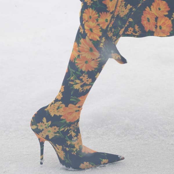 a model wearing blue and orange flora-print second-skin boots on the Balenciaga runway