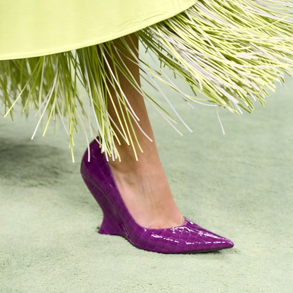a model wearing a purple croc-embossed wedge on the Bottega Veneta runway