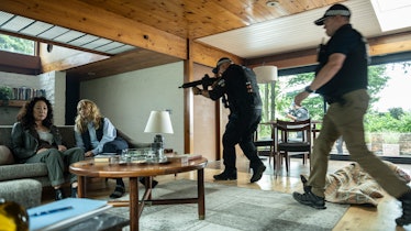 A law enforcement official pointing a gun at Villanelle in Killing Eve season 4 episode 3