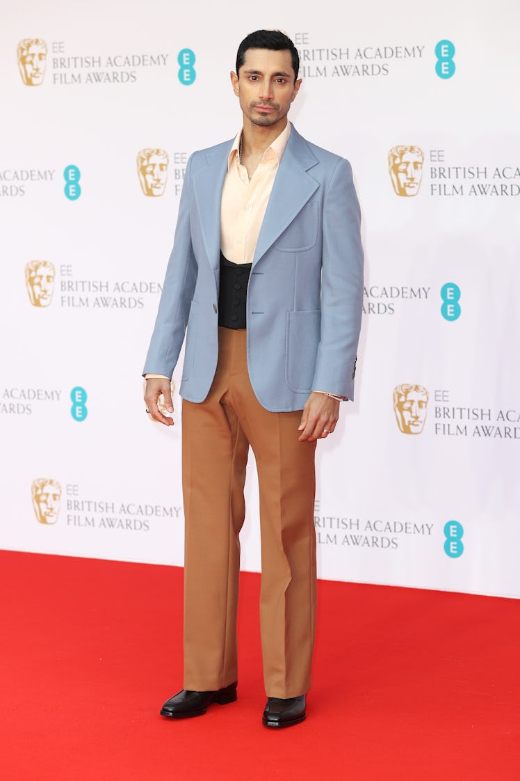Riz Ahmed wearing a pale blue blazer at the BAFTA Awards 2022