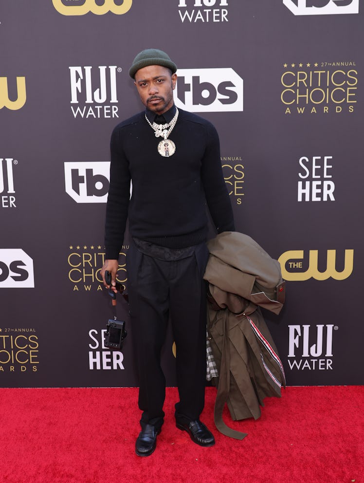 Lakeith Stanfield carrying a coat at the Critics Choice Awards 2022