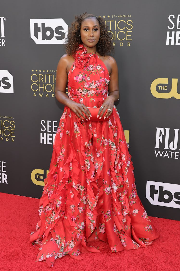 Issa Rae wearing a red floral gown at the Critics Choice Awards 2022