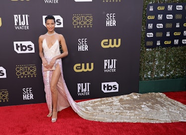 Indya Moore wearing a gown with a giant train at the Critics Choice Awards 2022