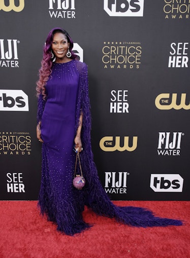 A purple-haired Dominique Jackson wearing purple at the Critics Choice Awards 2022