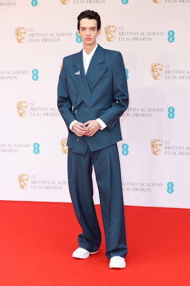 Kodi Smit-McPhee wearing a blue suit at the BAFTA Awards 2022