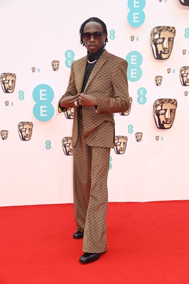 Michael Ajao wearing a printed brown suit at the BAFTA Awards 2022