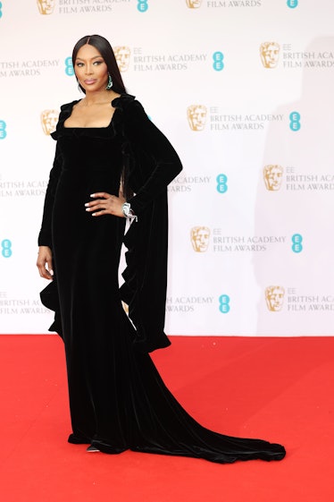 Naomi Campbell attends the BAFTA Awards 2022 wearing a black dress