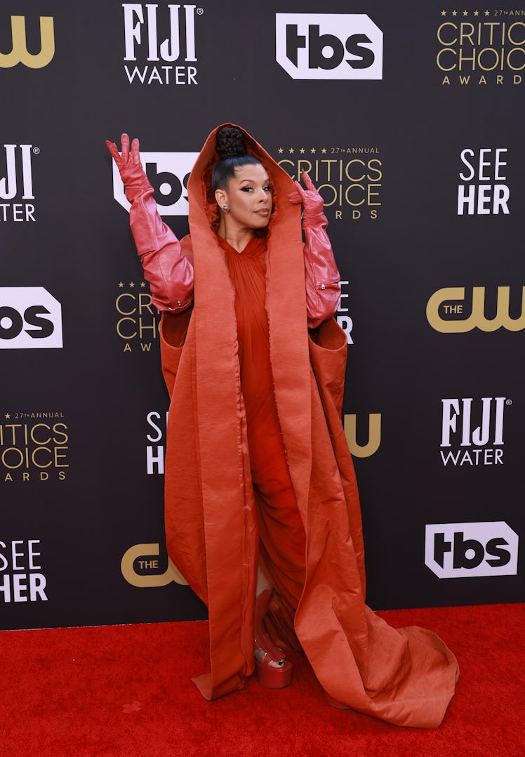 Hailie Sahar wearing a red ensemble with leather gloves at the Critics Choice Awards 2022