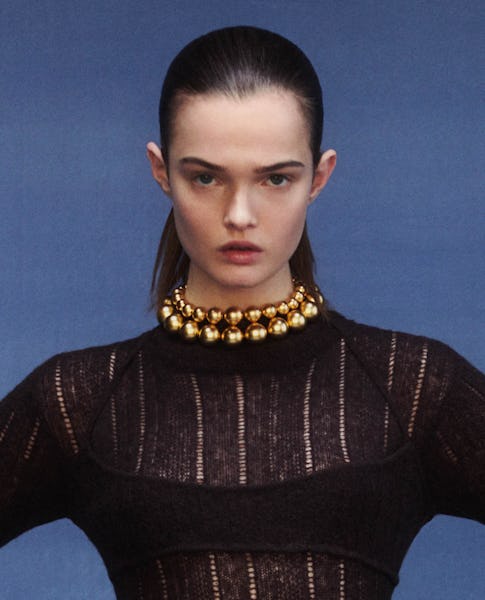 a model wearing two yellow gold ball chain necklaces by Jonathan Simkhai