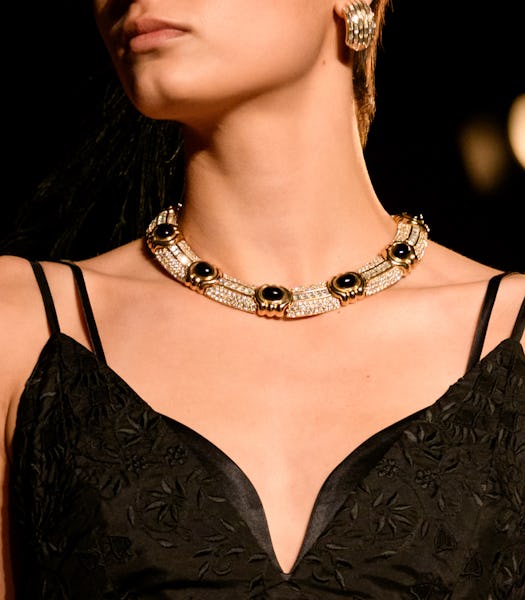a model wearing an antique-inspired necklace and earrings on the the Markarian runway