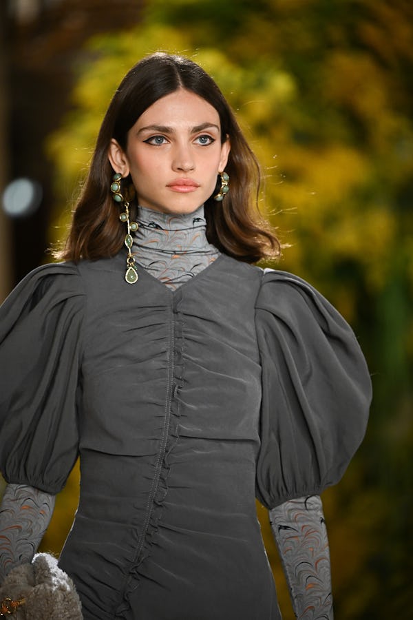 a model wearing a silver and turquoise earrings on the Ulla Johnson runway