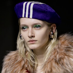 a model wearing large silver hoop earrings on the Gucci runway