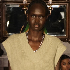 a model wearing a silver chain-link necklace on the Rejina Pyo runway
