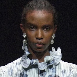 a model wearing large pearl earrings on the Erdem runway