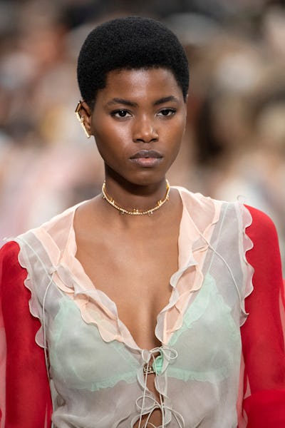 a model wearing a crystal choker necklace on the Fendi runway