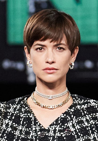 a model wearing layered choker necklaces on the Chanel runway