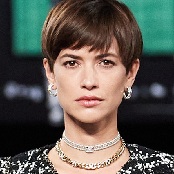 a model wearing layered choker necklaces on the Chanel runway