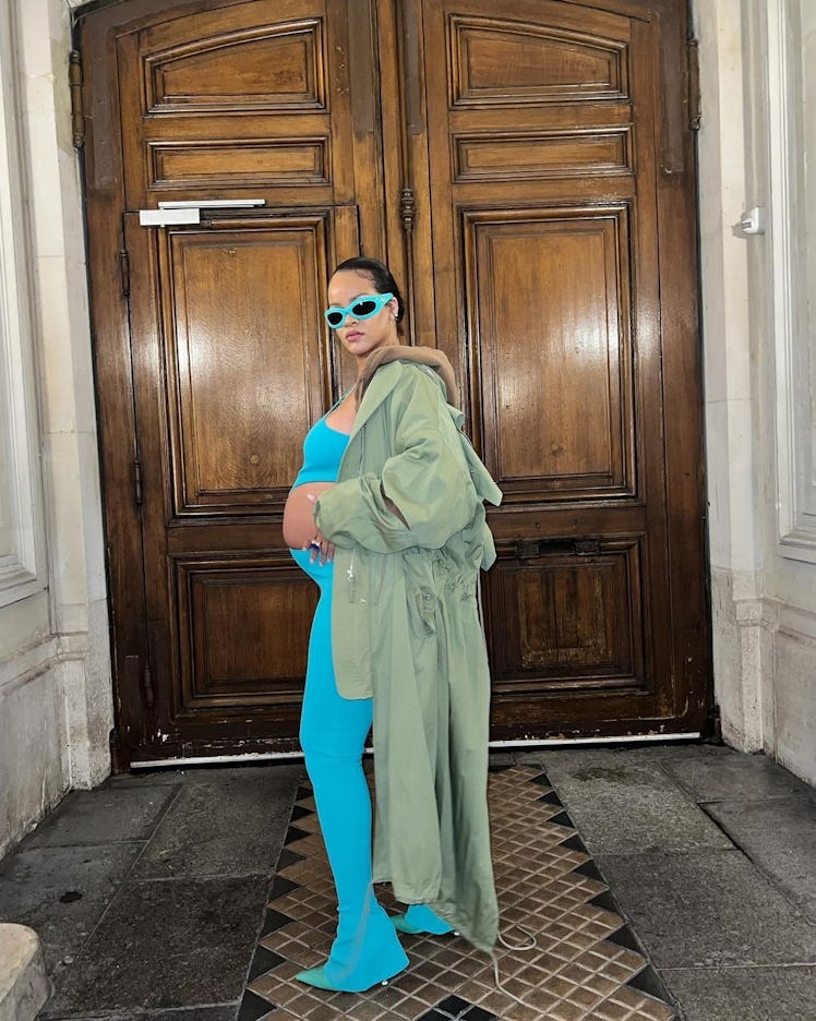 Rihanna wearing a blue jumpsuit that exposes her baby bump