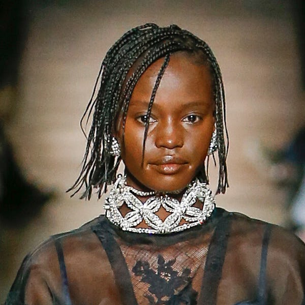 a model wearing a rhinestone crystal choker and earrings on the Miu Miu runway