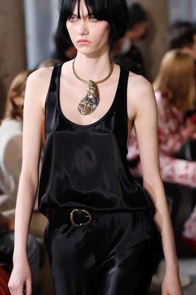 a model wearing a stone embellished silver necklace on the Etro runway
