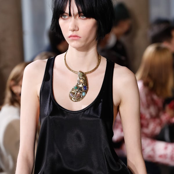 a model wearing a stone embellished silver necklace on the Etro runway