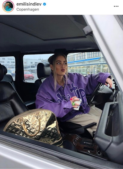 Influencer Emili Sindlev embraces the "car vibes" Instagram pose, which is one of the trendy instagr...
