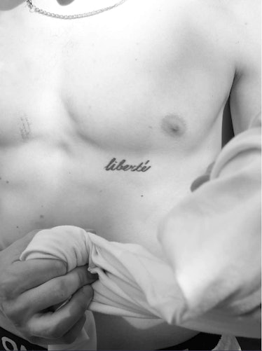 A black-and-white photo of a person's tattooed chest taken by Bogdan Shirokov