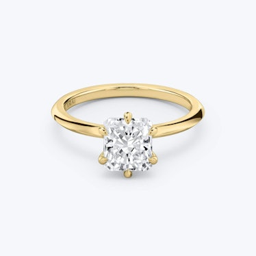 a knife edge yellow gold band engagement ring with a solitaire radiant cut diamond