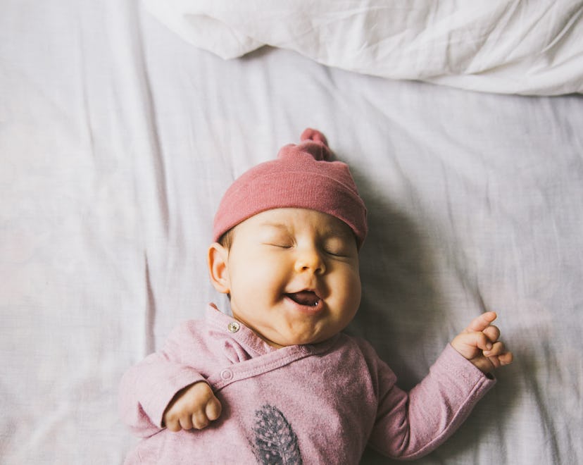 baby girl lying on bed, most popular girl names of all time