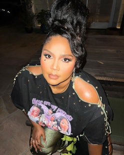 Lizzo with updo bun Harry Styles concert