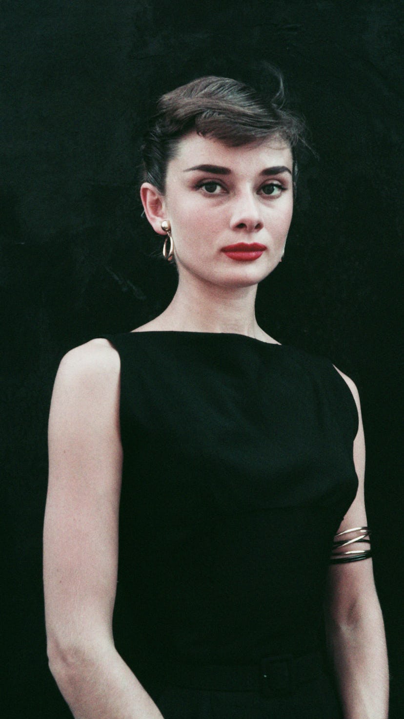 Audrey Hepburn in a black sleeveless dress circa 1955. 