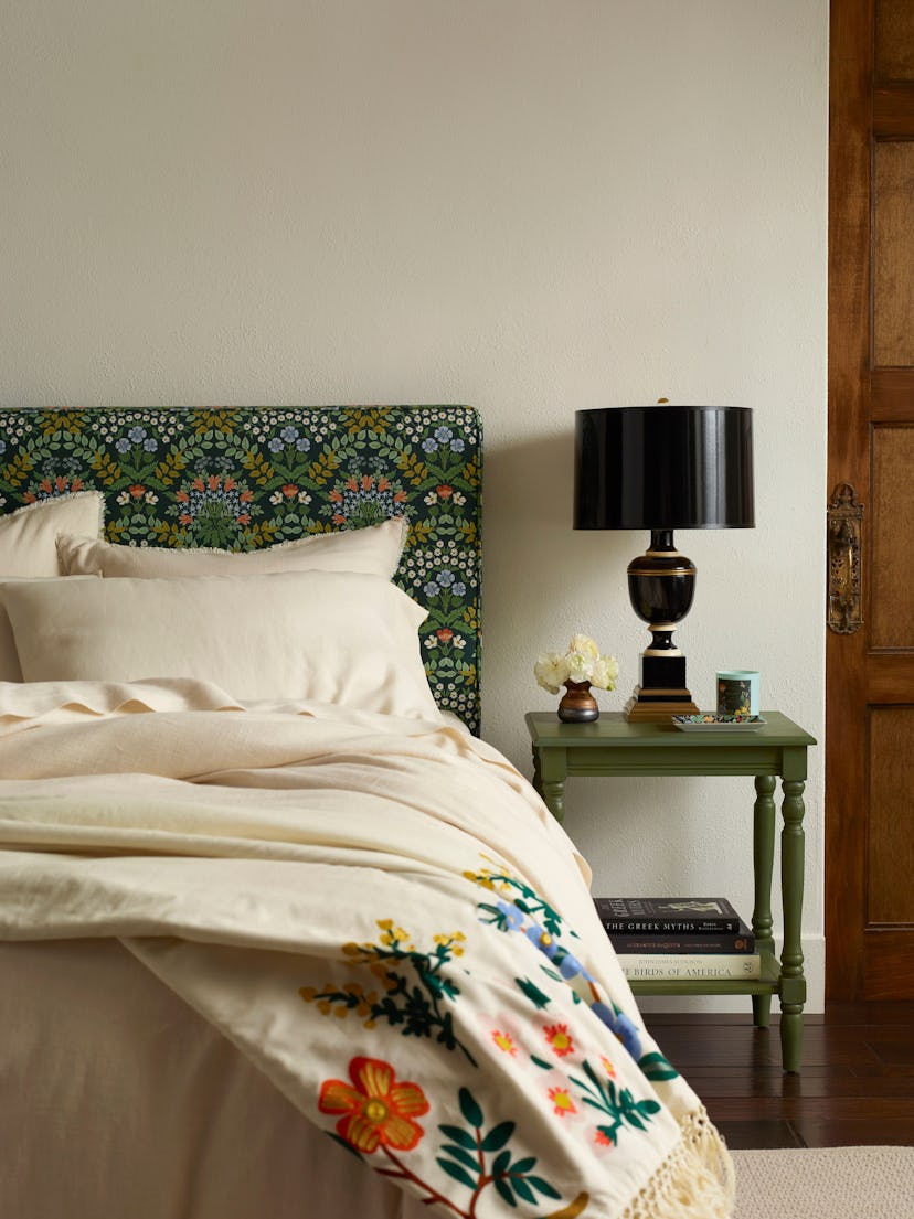 Bed with upholstered headboard in Rifle Paper Co. print