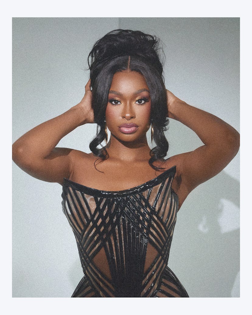 Coco Jones in a sheer, black, strapless dress