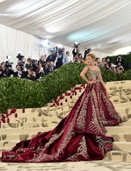 Blake Lively in a large wine-red dress at the 2018 Met Gala