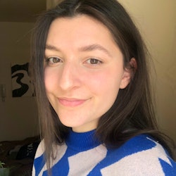 Maggie Haddad in the no-makeup makeup look and a white-blue sweater