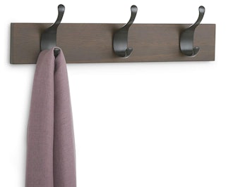 Wooden hook rack for purses and coats.