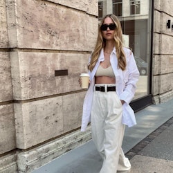 Blonde woman wearing an oversized button-down outfit