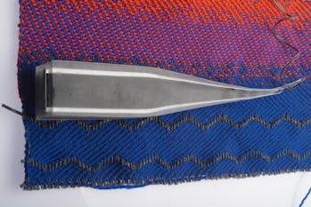 Blue, red, and purple stitched fabric.