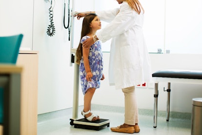 Little girl on scale in doctor's office