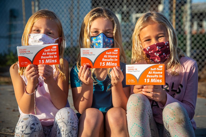 Kate Kahn,5, Savannah Harper,5 and Elyse Kahn,7, from left, pose for a picture holding their iHealth...