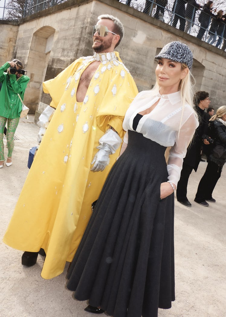 Two Paris Fashion Week attendees, wearing yellow and black and white