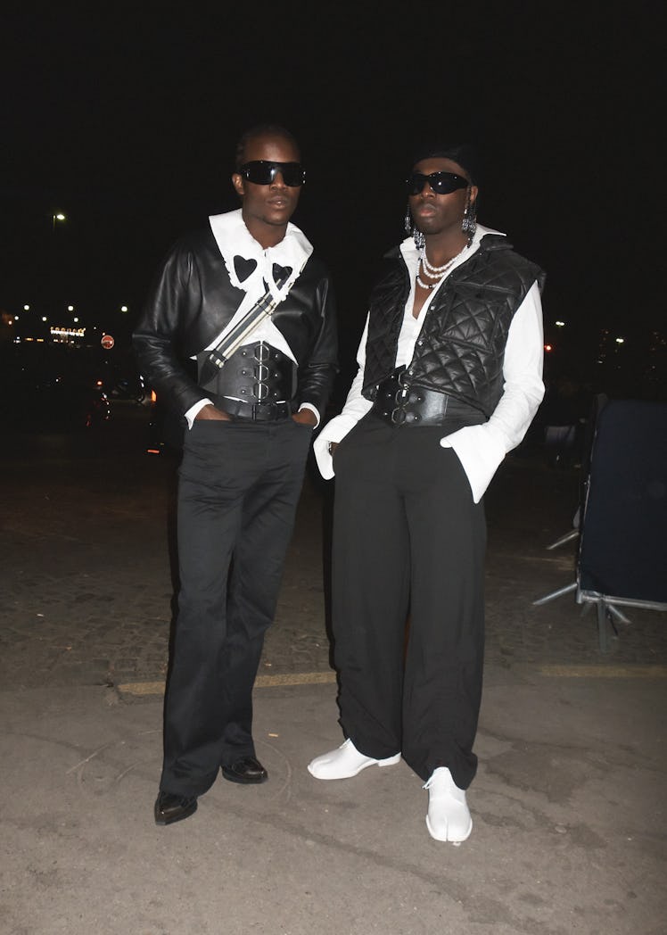 Two people wearing black and white at Paris Fashion Week