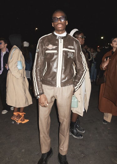 A person wearing a brown leather jacket at Paris Fashion Week