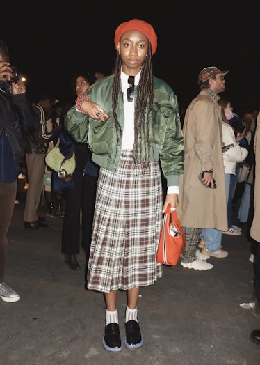 A person wearing a plaid skirt at Paris Fashion Week
