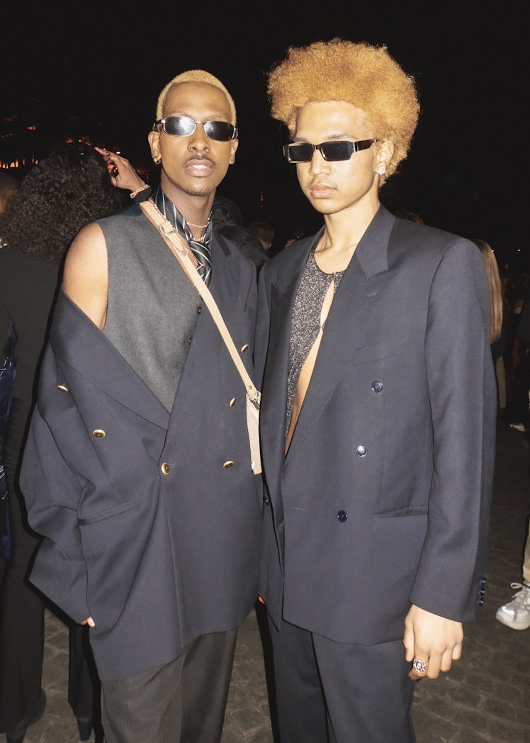 Two people wearing black at Paris Fashion Week