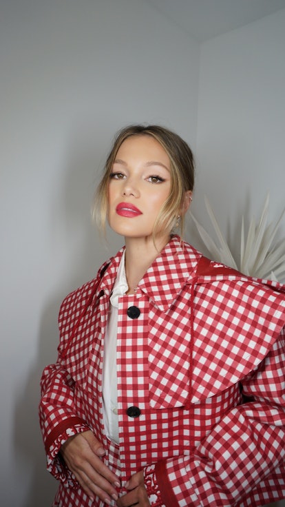 the actress Olivia Holt wearing a red and white gingham jacket by Dior
